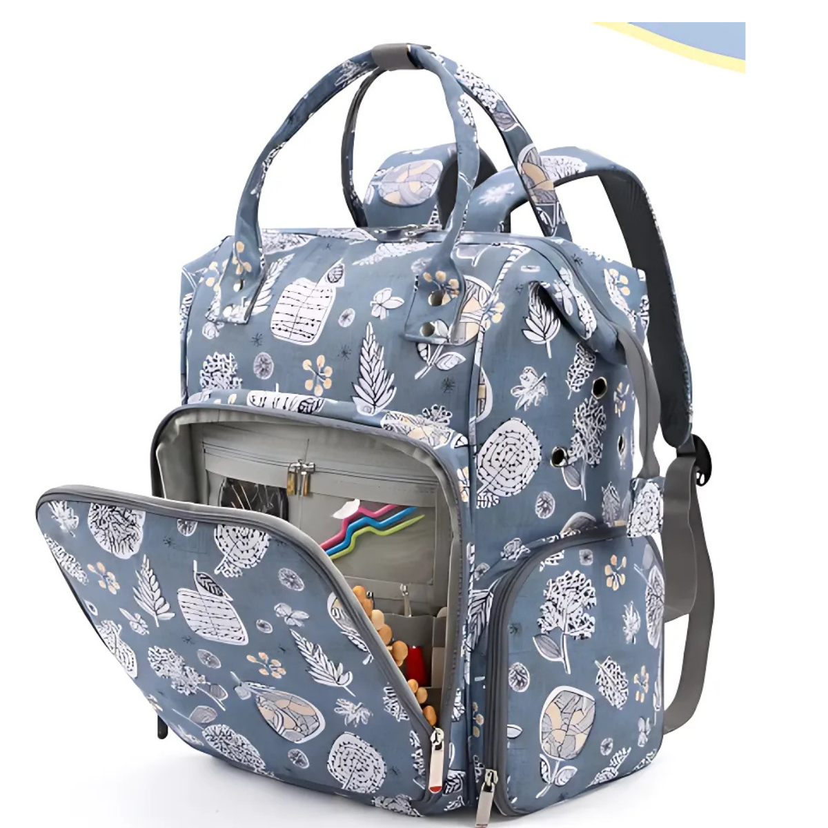 The Oxford Serenity Luxe Bag - Yarn Organizer features a blue and white floral pattern, a front pocket for easy access, and organized stationery inside—ideal as a stylish knitting bag or portable yarn organizer.