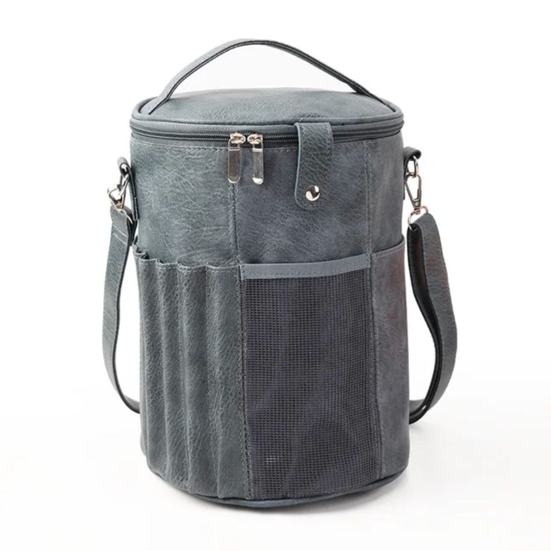 PU Leather Knitting Crochet Tools Storage Bag in gray features a cylindrical shape, top handle, and detachable strap. It includes side pockets and a zippered top, making it ideal for organizing crochet tools.