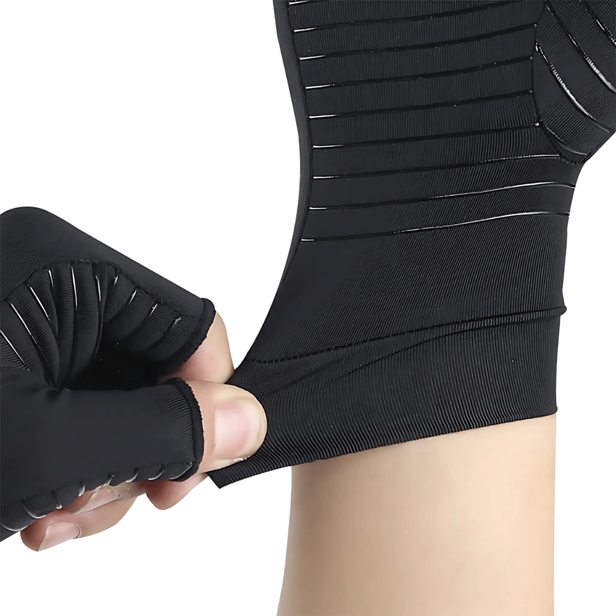 A hand stretches a black Arthritis Pain Relief Glove onto a wrist, highlighting its elasticity and fit—perfect for pain-free crafting, knitting, and crochet.