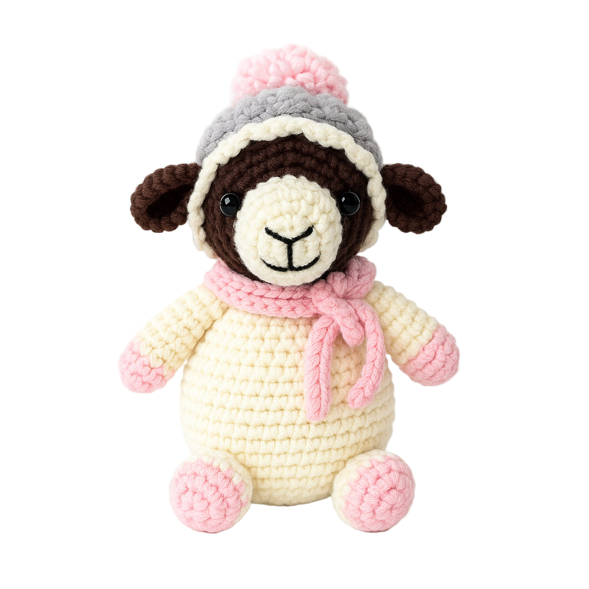 Wooly The Sheep Crochet Pattern features an adorable amigurumi sheep with a cream body, brown face, pink feet, gray and pink hat, and a pink scarf, sitting against a plain white background.