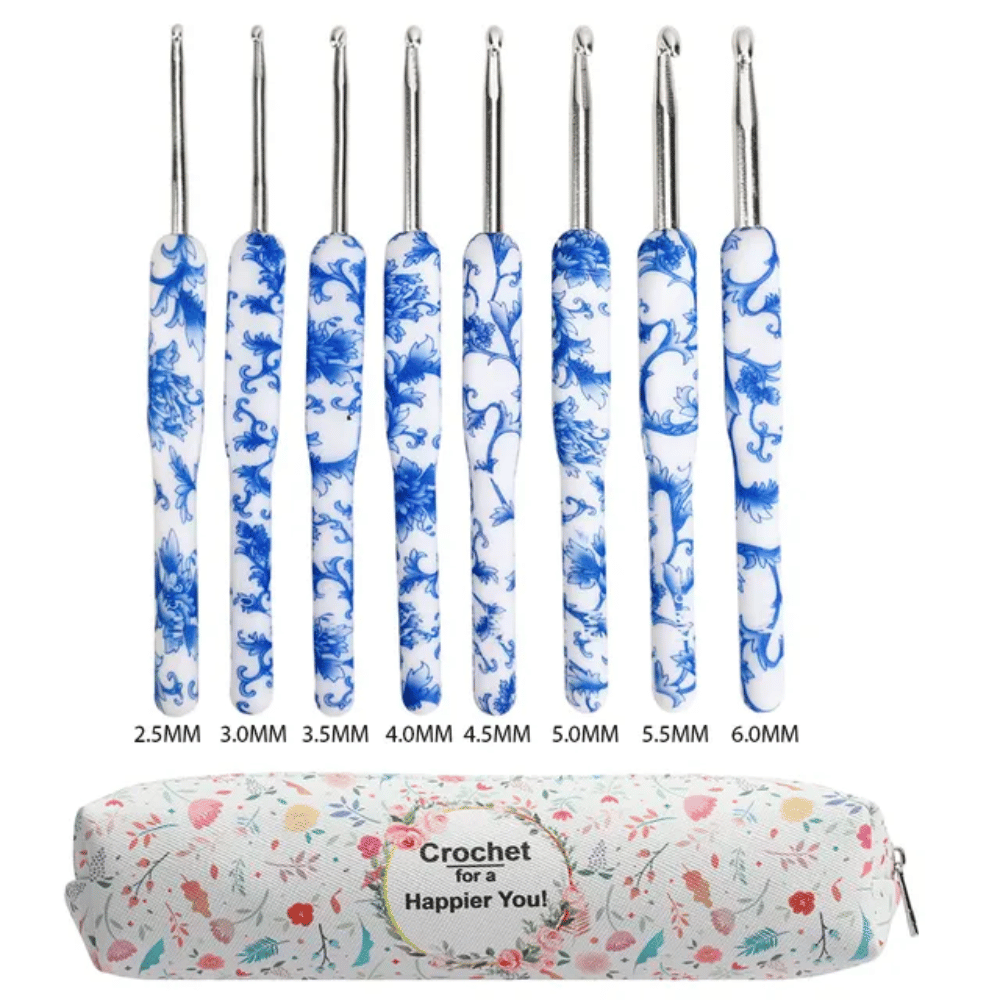 The Delux Ergonomic crochet hook set, featuring hooks in blue and white sizes from 2.5mm to 6.0mm, is neatly stowed in a floral pouch marked "Crochet for a Happier You!" and includes a portable carrying case for convenient transportation.