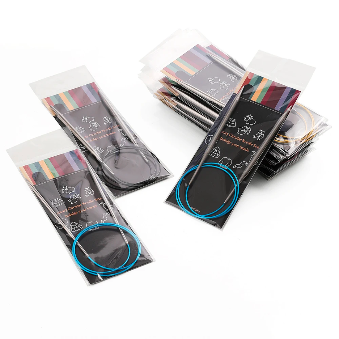 The Stainless Steel Knitting Needle Set comes in clear plastic packaging, each featuring colorful stripes and small icons, showcasing the durable stainless steel knitting tools. They are neatly arranged on a white background, ready to meet all your knitting needs.