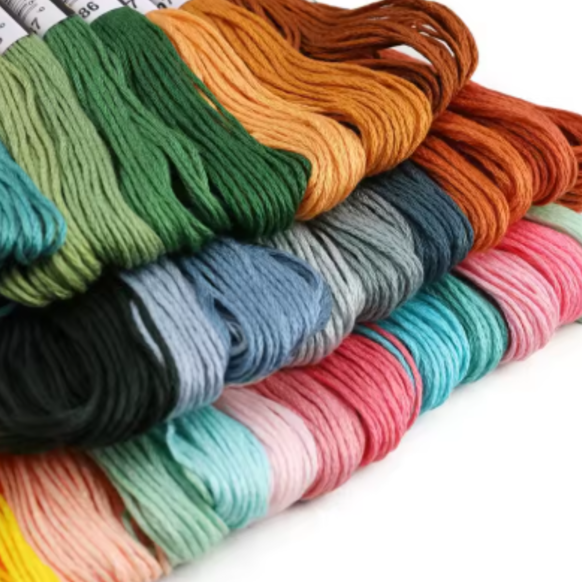 The Embroidery Floss Set features multiple skeins of cotton threads in green, orange, blue, pink, and yellow—ideal for embroidery crafts or crochet projects.