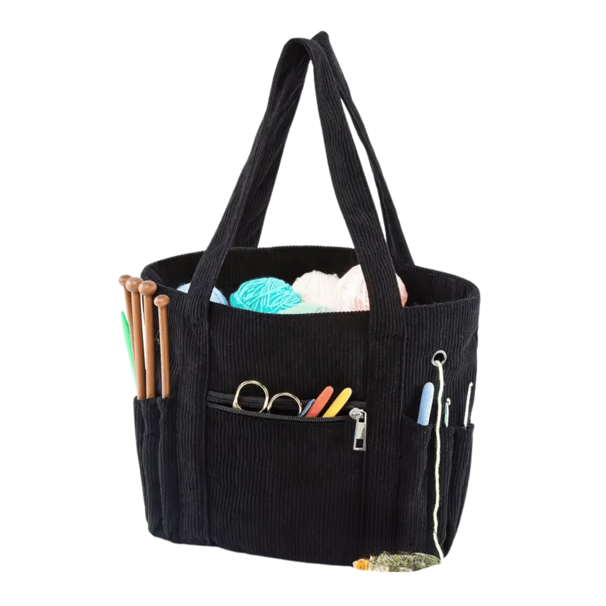 The Crochet & Knitting Organizer Tote, a black fabric bag, holds yarn, knitting needles, scissors, crochet hooks, and other tangle-free crafting tools. Photographed on a white background.