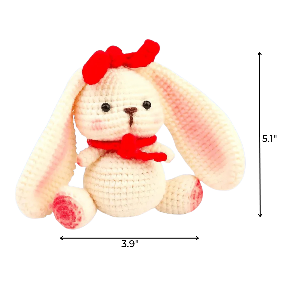 The Crochet Rabbit Kit features a plush bunny with long ears, a red bow, and scarf, sitting upright—ideal for DIY projects or beginner crochet kits. Finished size: 5.1 inches tall by 3.9 inches wide.