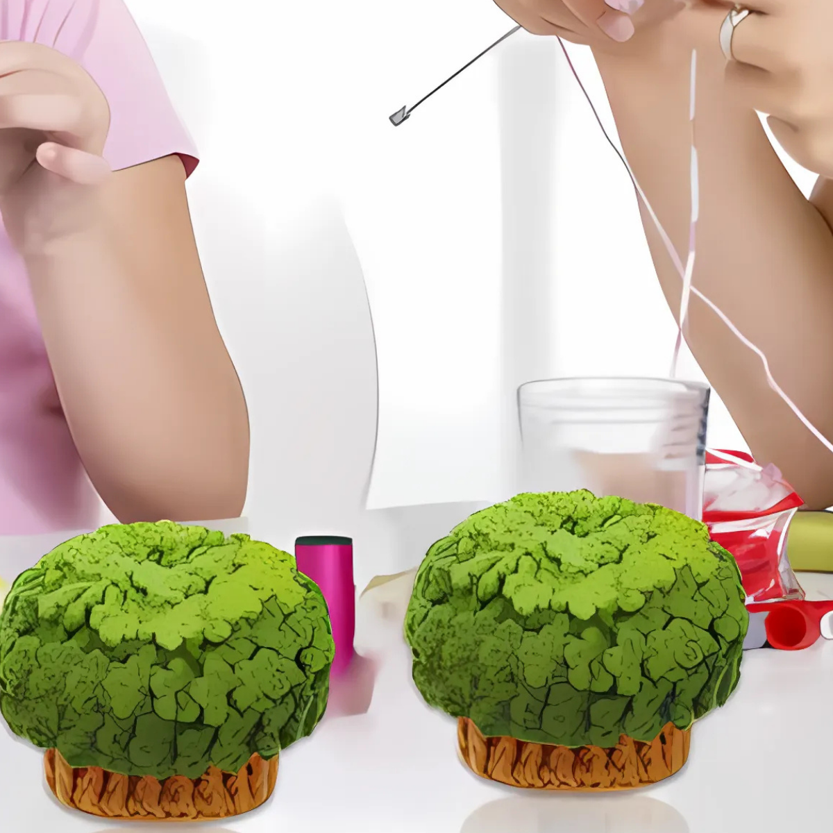 Two people work on a craft project at a table with green sponge-like pieces, wool yarn, a threaded needle, and supplies—likely creating handmade coasters using the Plant Crochet Coaster Kit.