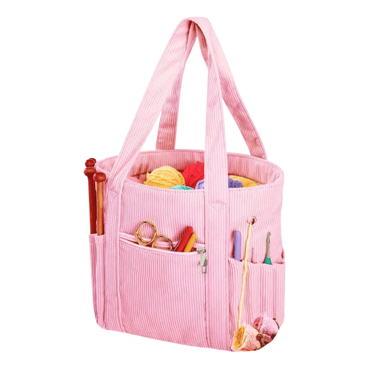 The Crochet & Knitting Organizer Tote is a pink fabric bag for tangle-free crafting, featuring yarn balls, knitting needles, scissors, crochet hooks, and other tools stored in its multiple pockets.