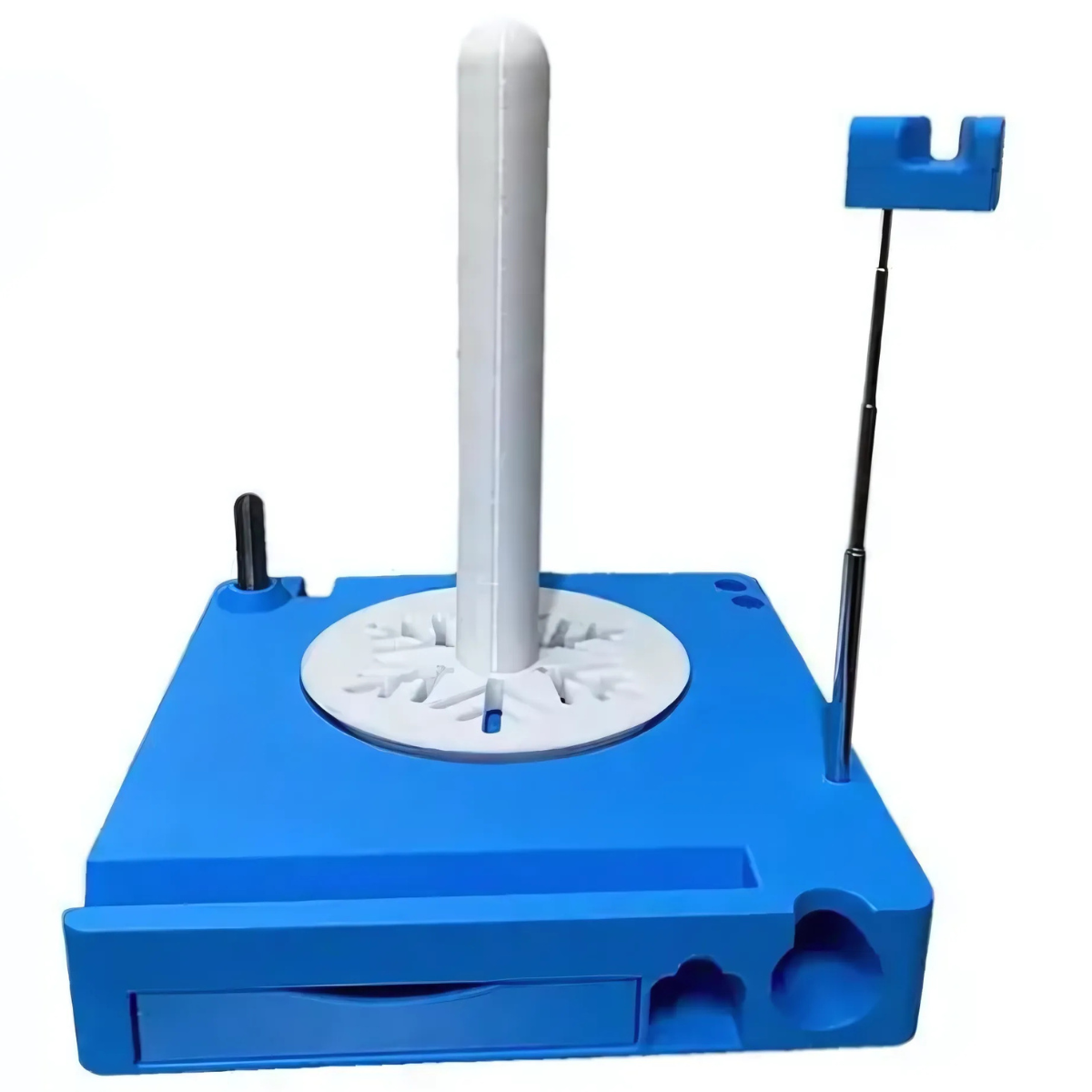 The Spinning Yarn Holder with Tool Storage features a blue plastic base, tall white central rod, front slot, black peg, and a metal pole with blue attachment—ideal for tangle-free yarn and organized tool storage.