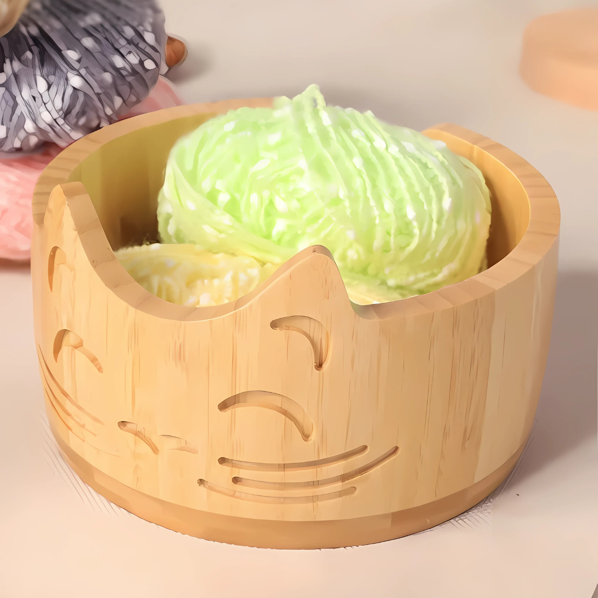 The Cat Yarn Bowl features a carved cat face design and is perfect for holding two scoops of pastel-colored ice cream.