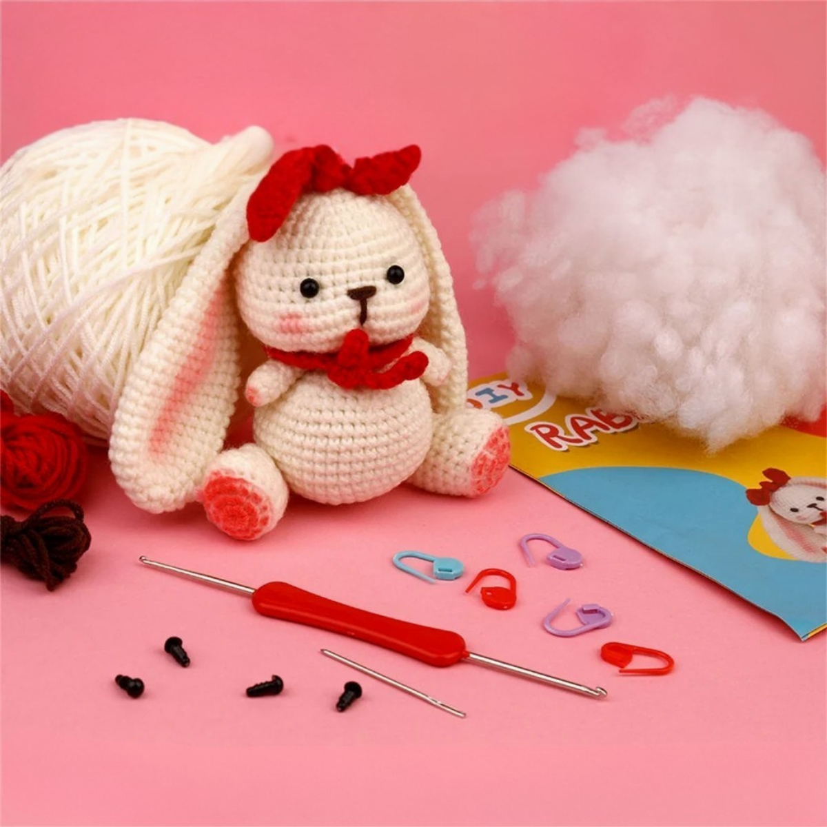 The Crochet Rabbit Kit includes yarn, stuffing, crochet hooks, safety eyes, stitch markers, and an instruction booklet—everything beginners need to make a cute bunny.