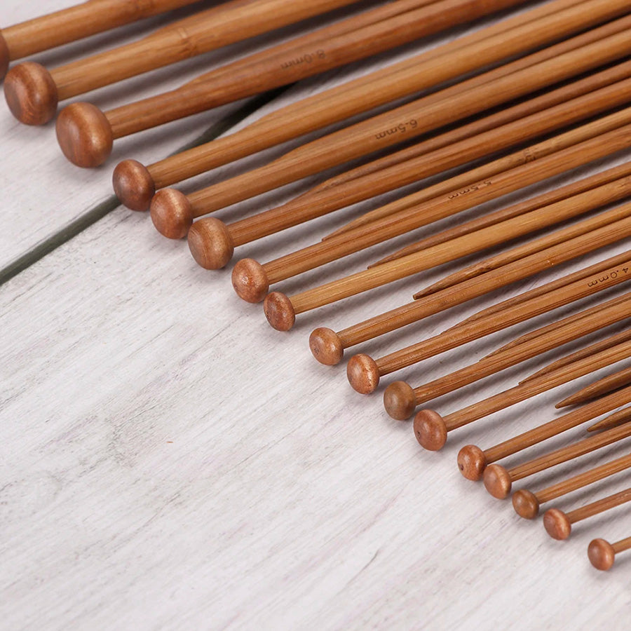 The "36 Pcs Bamboo Knitting Needles" set features varying sizes with a smooth finish, arranged on a light wooden surface to provide a comfortable knitting experience.