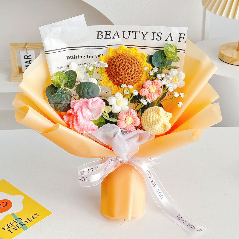 Discover the "Crochet Sunflower Bouquet: Blooms That Never Wilt," showcasing an exquisite arrangement of crocheted sunflowers, roses, and green leaves, all tastefully wrapped in vibrant orange paper.