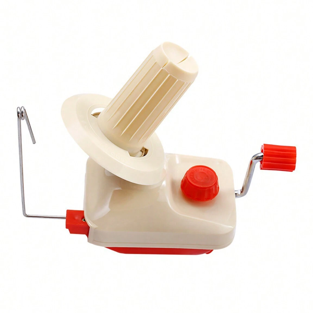 The Yarn Ball Winder features a cream and red plastic body, rotating spindle, metal yarn guide arm, and an easy-to-use red hand crank for quick, uniform yarn ball winding.
