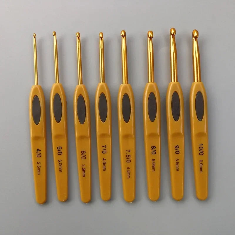 The Crochet Hook Set 8 Pcs includes eight ergonomic hooks with yellow handles, available in sizes from 2.5mm to 6mm, all beautifully arranged on a gray background.