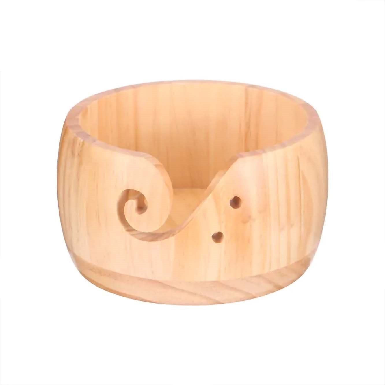 Introducing the Handmade Wooden Yarn Bowl, designed with a beautiful spiral cutout and two convenient holes to easily thread your yarn.