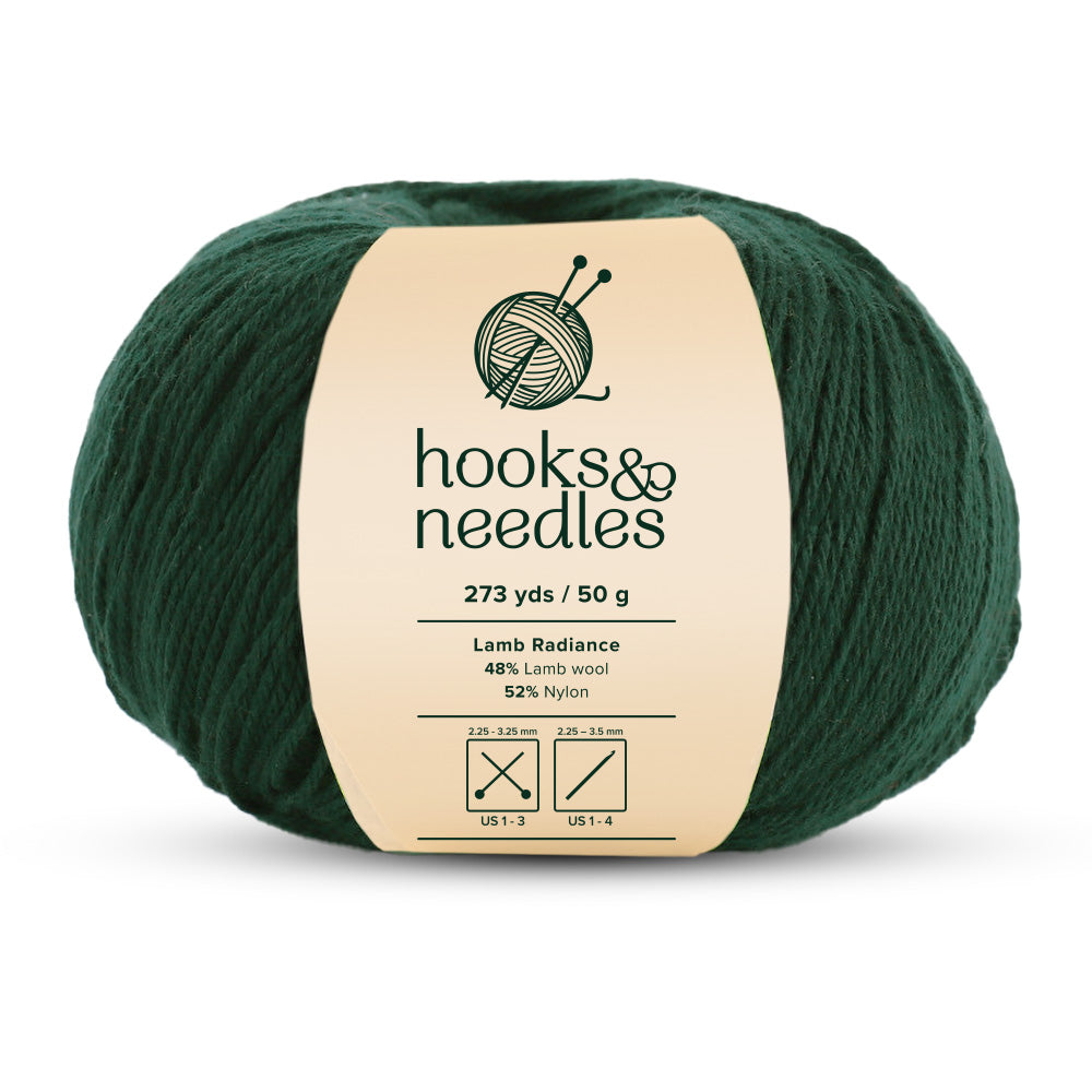 Introducing the "Lamb Radiance Yarn 50g," a ball of lush green yarn from the "hooks & needles" collection. This luxurious super fine-weight yarn offers 273 yards in a 50-gram ball, featuring an exquisite blend of 48% lamb wool and 52% nylon. Enjoy unmatched Lamb Radiance in every stitch.