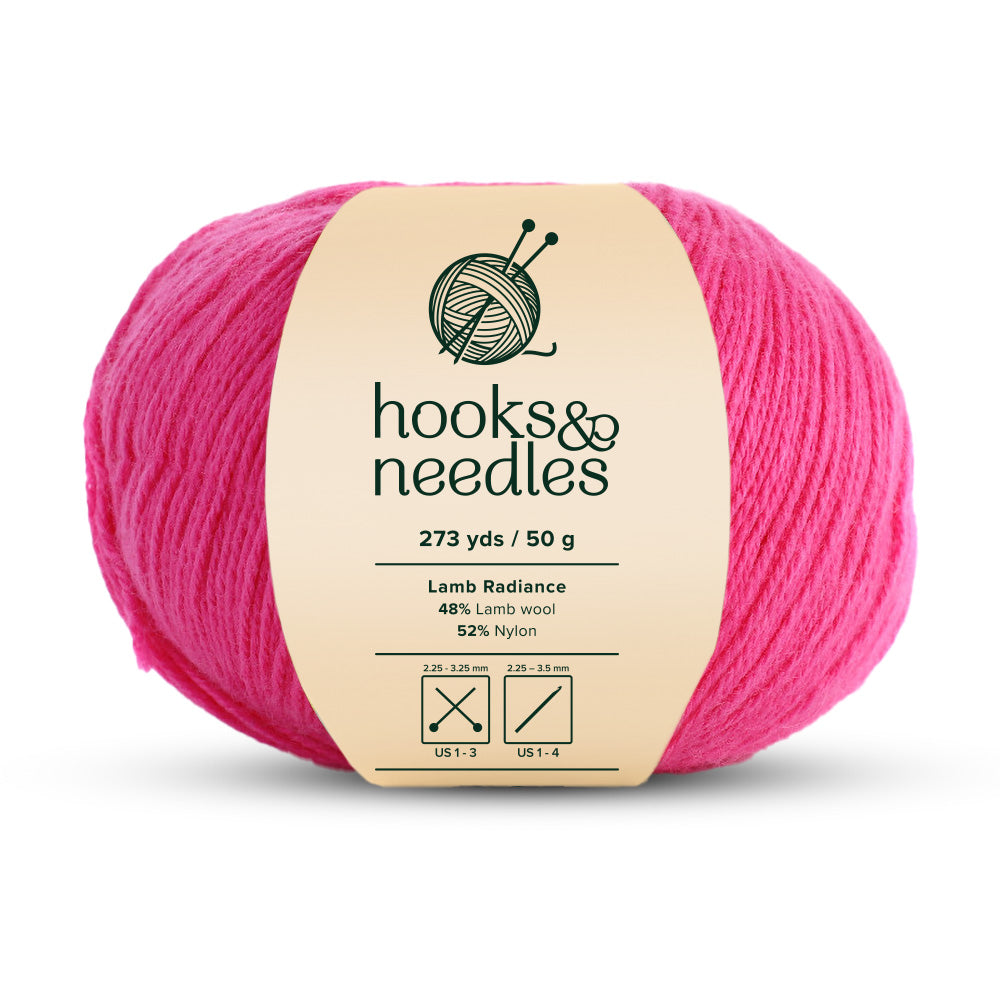 The Lamb Radiance Yarn 50g is a ball of pink yarn that exudes the softness of lamb wool, combining 48% lamb wool with 52% nylon. As a super fine-weight yarn, it provides 273 yards per 50g and is ideal for knitting and crochet needle sizes.