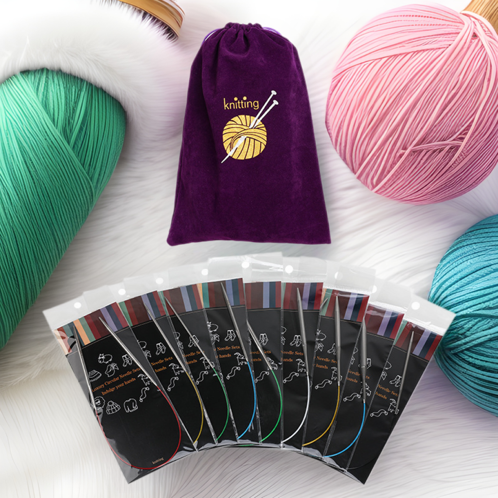 A purple drawstring bag and several packs of the Stainless Steel Knitting Needle Set are displayed among large yarn balls—ideal for organizing your knitting projects.