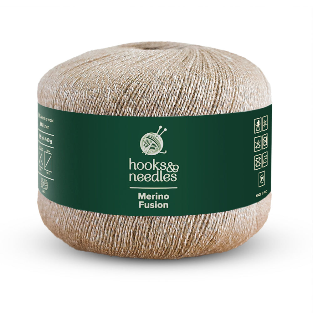 A 40g ball of beige Merino Fusion lace-weight yarn, wrapped in a green label decorated with knitting symbols and text.
