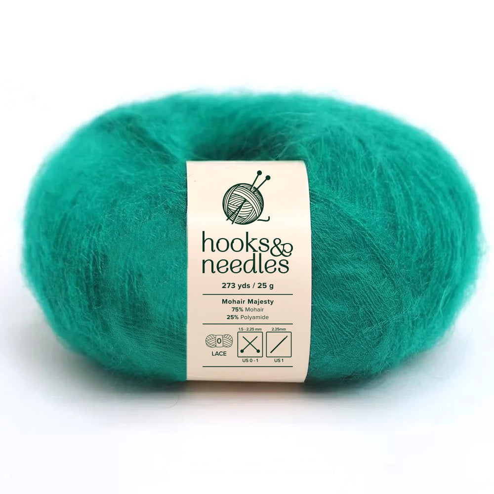 The Mohair Majesty Yarn 25g, available in a rich teal shade under the "hooks & needles" brand, offers a sumptuous texture. With a composition of 75% mohair and 25% polyamide, each skein weighs 25g and extends to 273 yards, making it perfect for creating intricate lace-weight projects.