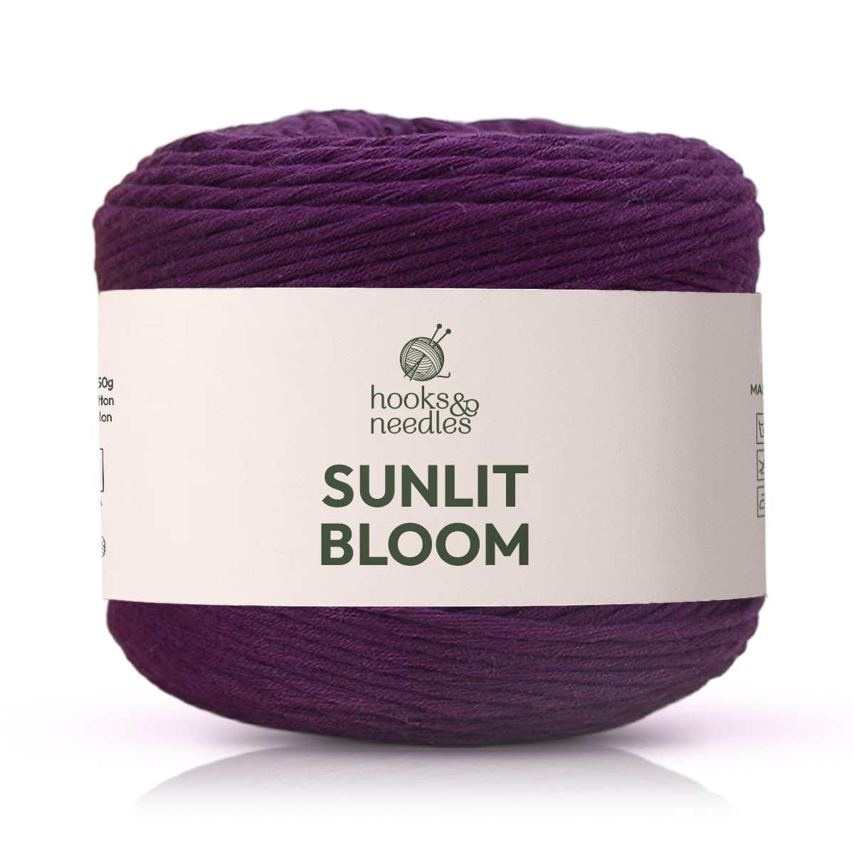 A skein of deep purple "Sunlit Bloom Yarn" with a white label and knitting needles logo—ideal as a medium weight cotton yarn for your next project.