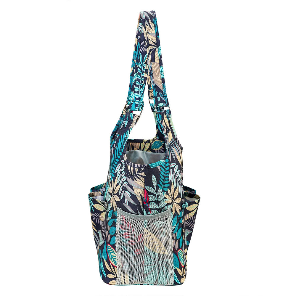 Introducing the "Yarn Tote Bag: Knit on The Go"—a vibrant, patterned tote bag featuring a tropical leaf design in blue, teal, and beige tones. Equipped with multiple pockets and long handles, it's perfect for holding all your knitting essentials.