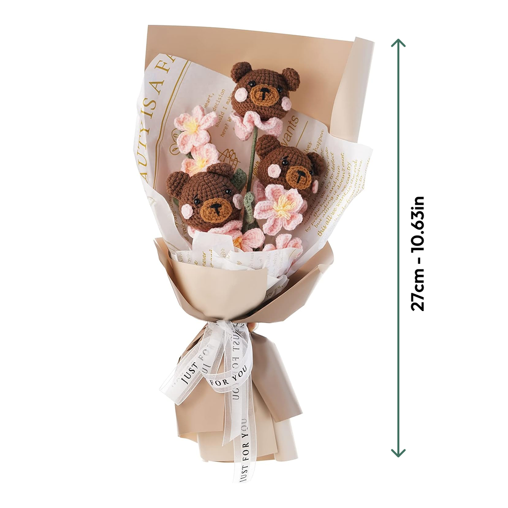The DIY Crochet Bear Bouquet Kit features crocheted brown bear heads and pink flowers, wrapped in beige paper with a white ribbon. This 27 cm (10.63 in) bouquet adds handmade charm to any space.