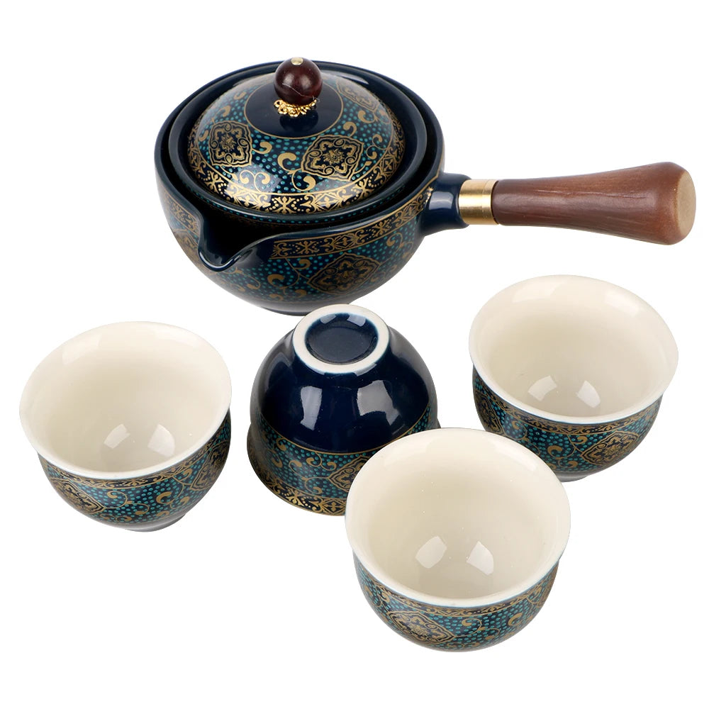 The Tea Making Set With Cups and Case features a blue and gold teapot adorned with intricate patterns, complemented by a wooden handle. It includes four matching porcelain teacups arranged elegantly around it, making it an essential addition for any tea connoisseur.