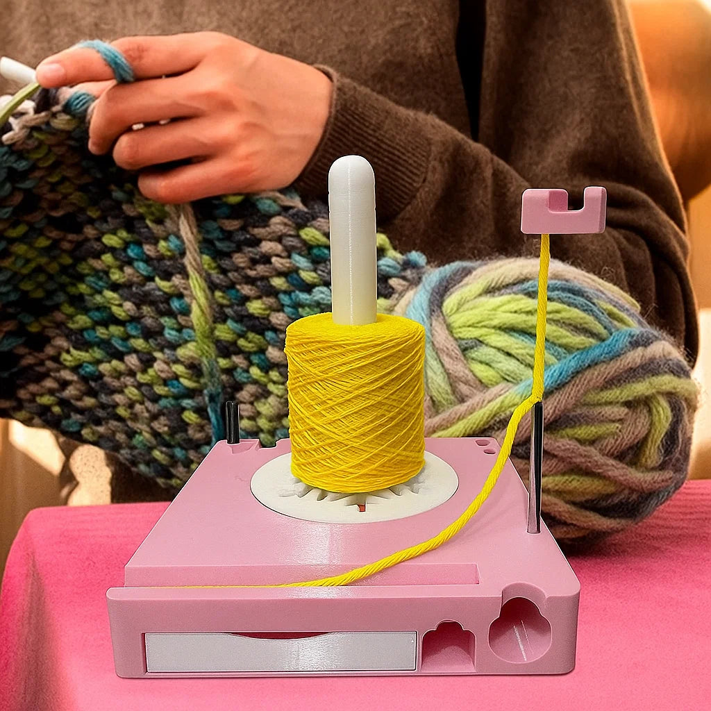 A person knits with multicolored yarn in the background. In the foreground, a yellow yarn cake sits on a Spinning Yarn Holder with Tool Storage, which keeps yarn tidy and tools organized on the table.