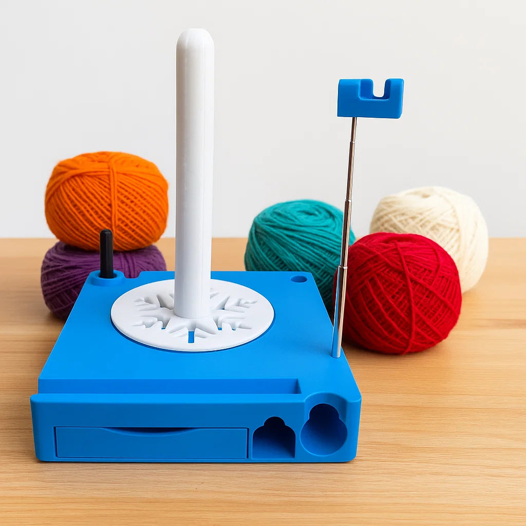 The Spinning Yarn Holder with Tool Storage, featuring a spindle and metal guide arm for smooth yarn flow, sits on a table with four colorful yarn balls arranged behind it.