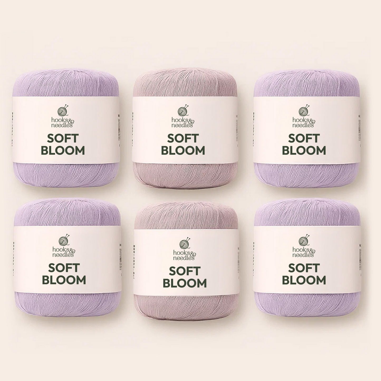 Six skeins from the Hooks & Needles Yarn Subscription Box in light purple and mauve are arranged in two rows on a plain background.