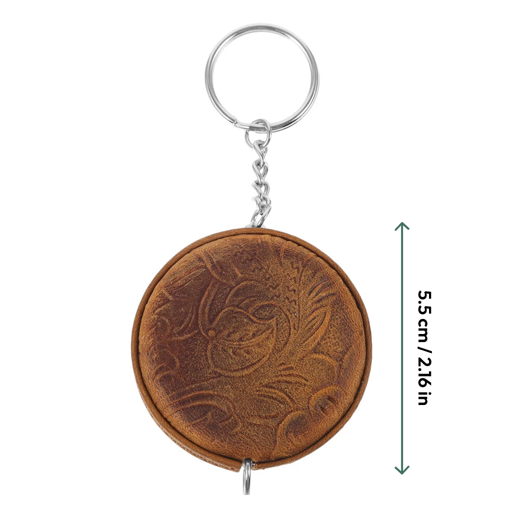 Mini Leather Tape Measure 60" in brown leather with embossed floral pattern and vintage charm, attached to a metal keyring; vertical arrow indicates height of 5.5 cm (2.16 inches).