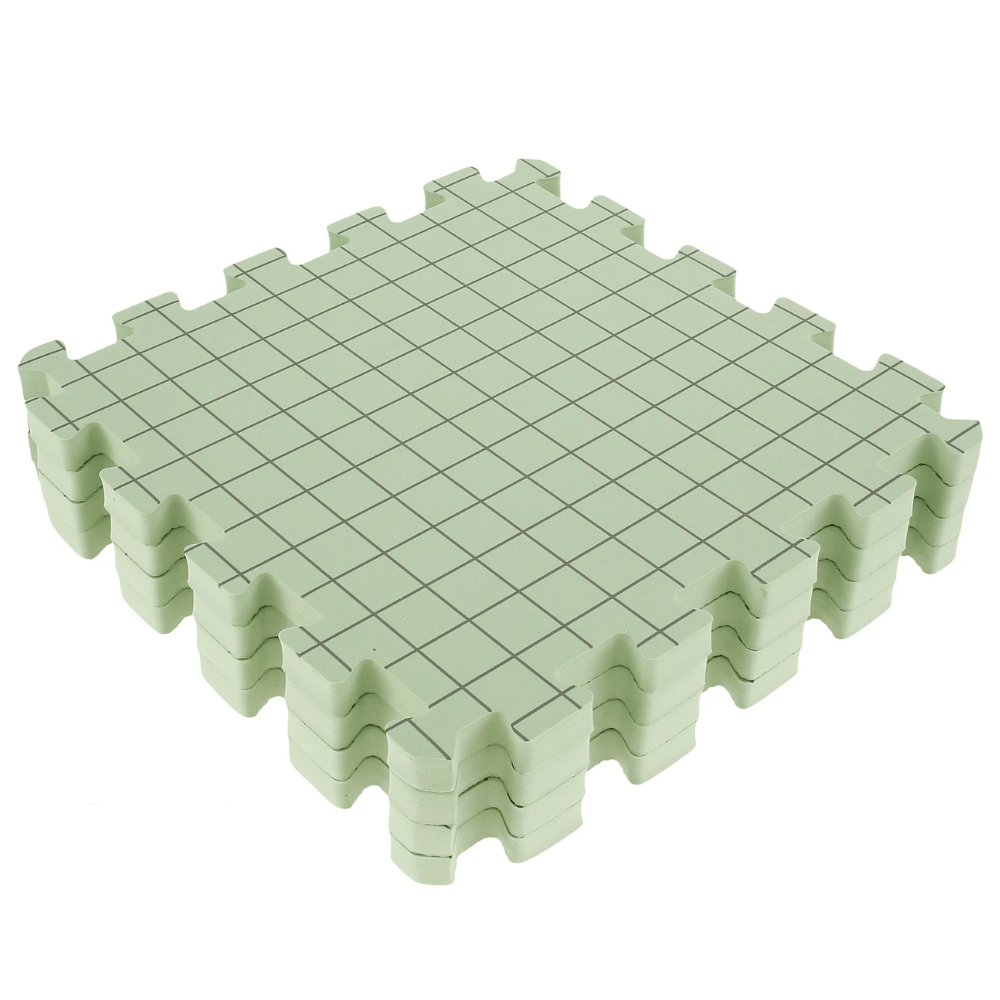 A set of interlocking green foam tiles featuring a grid pattern, ideal for use as a portable crafting platform or as Knitting Crocheting Blocking Mats.