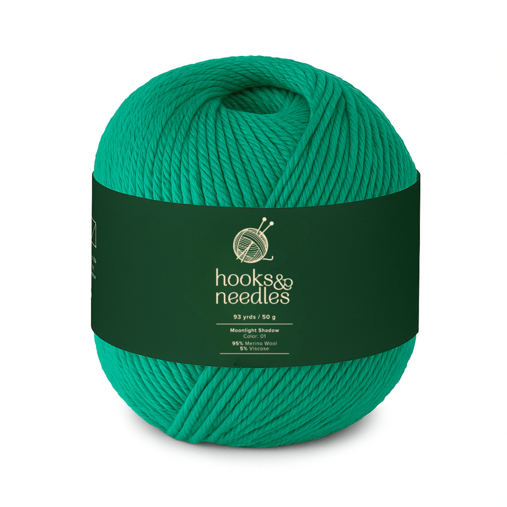 Moonlight Shadow is a 50g ball of bright green, medium-weight yarn (mostly cotton, 93 yards) labeled "hooks & needles," featuring knitting needles on the label—perfect for crafting elegant scarves.