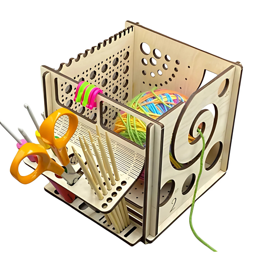 The Yarn and Tools Organizer Box stores scissors, crochet hooks, knitting needles, and colorful yarn, featuring a circular opening that lets you easily pull yarn while keeping all your crafting tools organized.