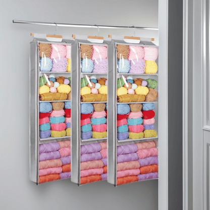 Three Hanging Yarn Storage Organizers, each filled with colorful skeins, provide a vibrant and organized yarn storage solution for your closet.