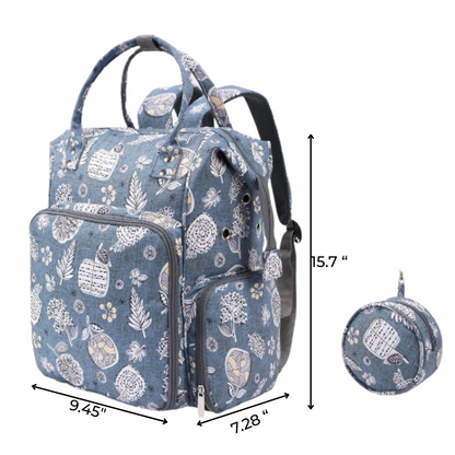 The Oxford Serenity Luxe Bag - Yarn Organizer features blue floral print, front and side pockets, a matching round pouch, and measures 15.7"H x 9.45"W x 7.28"D—ideal for crafters as a stylish knitting bag or yarn organizer on the go.