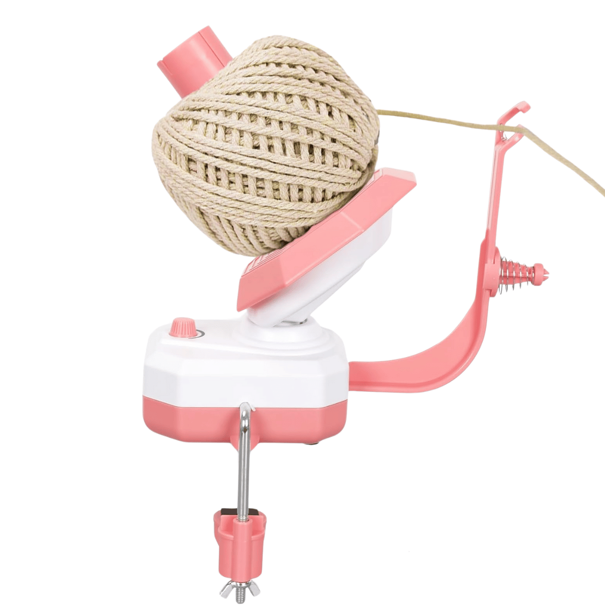 An Electric Yarn Winder in pink and white, with a beige yarn ball loaded and clamped to the edge of a surface, ready for winding.
