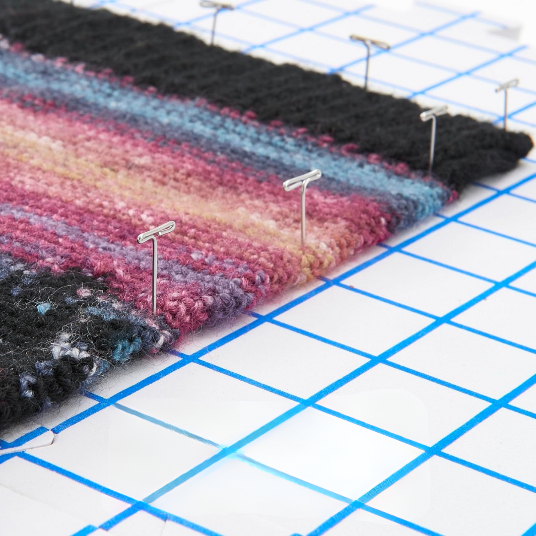 Close-up of a multicolored fabric being blocked on a grid mat with rust-resistant T-Pins For Blocking.