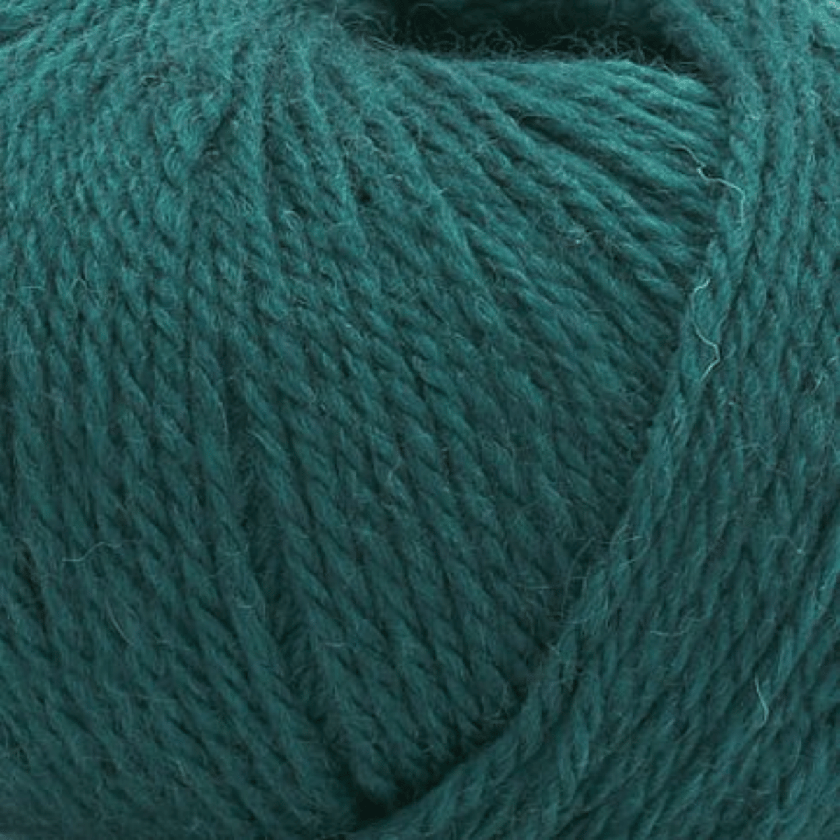 A close-up view of Aurora Gemstones yarn, showing the texture and strands of its soft cotton and acrylic blend in a beautiful teal shade.
