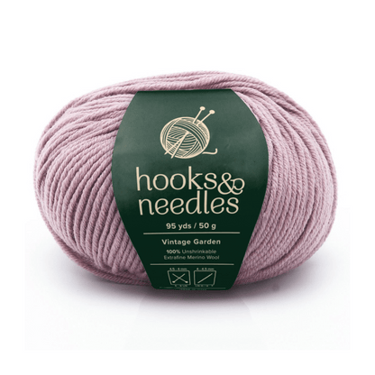 A 50g ball (95 yds) of "hooks & needles" Aurora Gemstones Yarn in Vintage Garden, 100% extra fine mercerized wool, soft and light purple for luxurious projects.