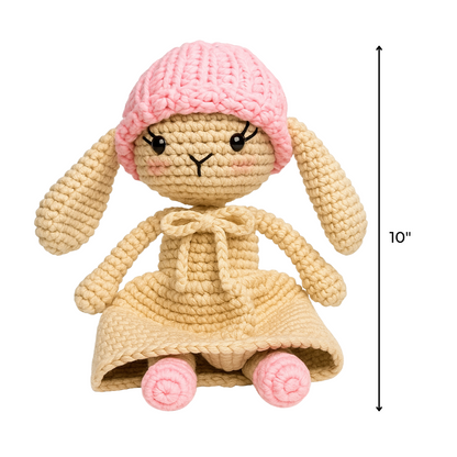 Rosie The Bunny Crochet Pattern creates a 10-inch tall crocheted beige bunny with long ears, a pink knit hat, and dress—perfect for beginners who want an adorable handmade toy using this digital pattern.