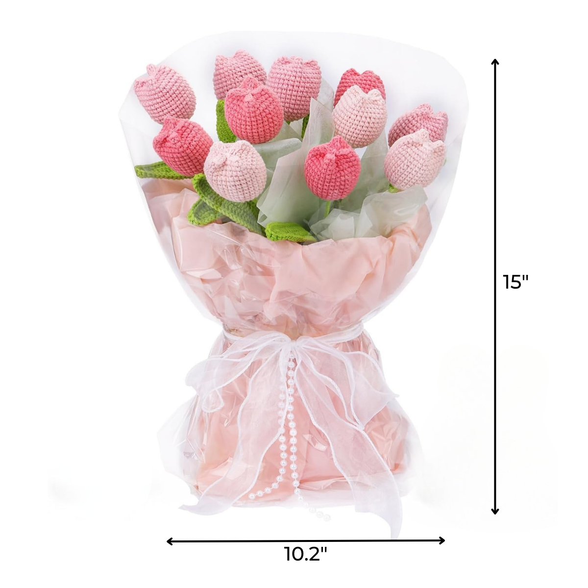 The Crochet Tulip Bouquet Kit features pink everlasting tulips, artfully wrapped in pink and white tissue with a white ribbon bow; finished bouquet is 15 inches tall by 10.2 inches wide—perfect as a unique crochet gift.