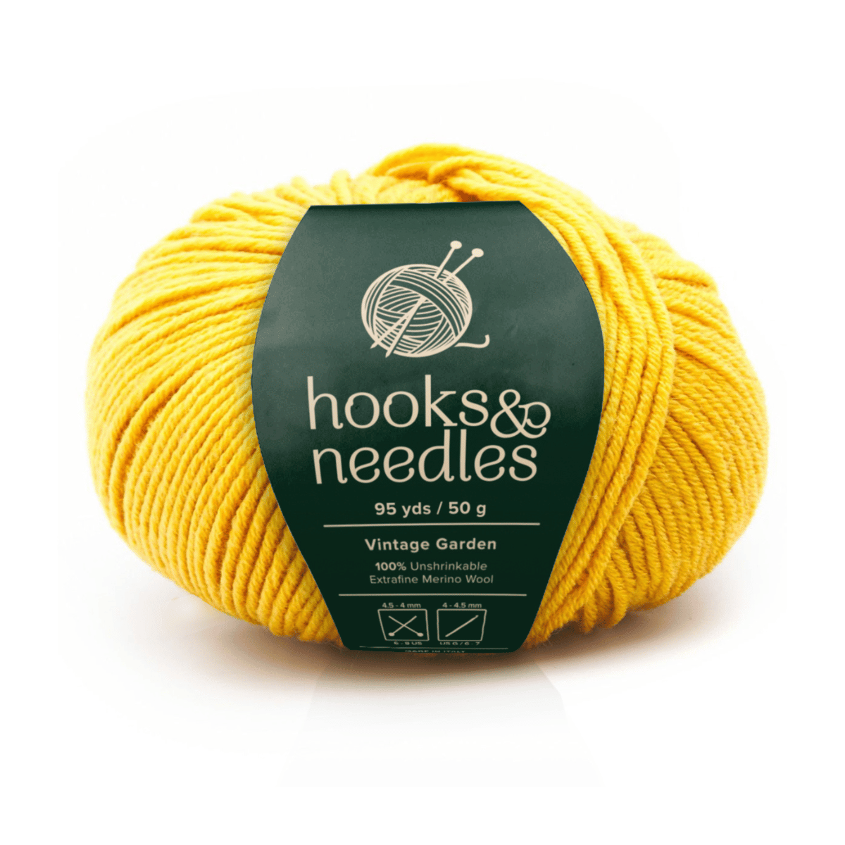 A 50g, 95yd ball of yellow "Vintage Garden" yarn (100% extra-fine merino wool) labeled "hooks & needles" offers luxurious softness with clear washing and ironing care symbols on the label.
