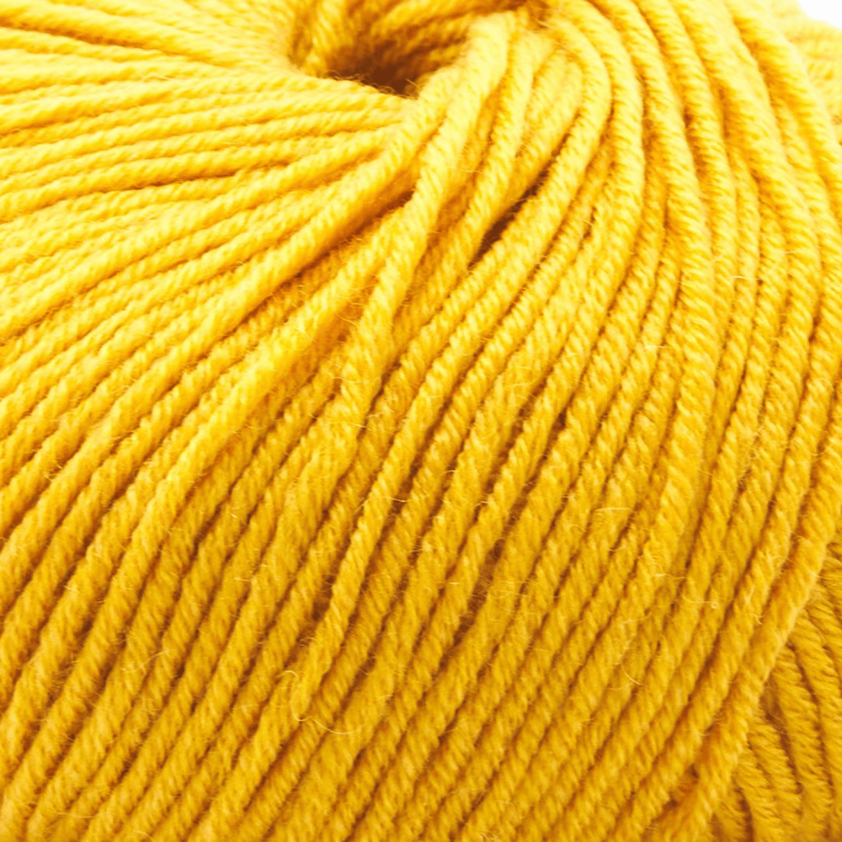 Close-up view of a skein of bright yellow Vintage Garden yarn, showcasing its detailed texture, individual strands, and luxurious softness.