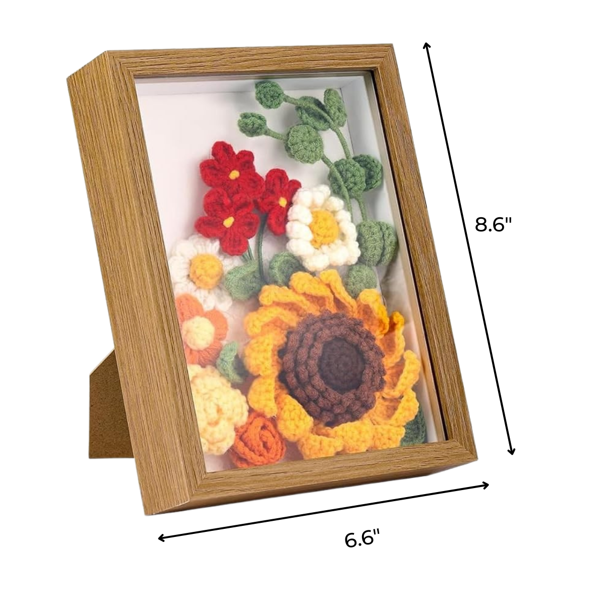 The Sunflower Crochet Kit with Frame features crocheted flowers, including a sunflower, in a brown wooden shadow box (8.6" x 6.6") with clear glass—adding a charming touch to your home décor.