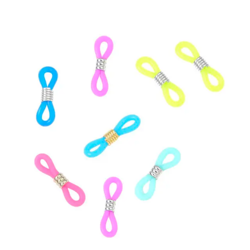 The Knitting Needle Holder 16pcs, featuring colorful double-looped bands with silver or gold wraps, resembling vibrant knitting accessories, are scattered on a white background.