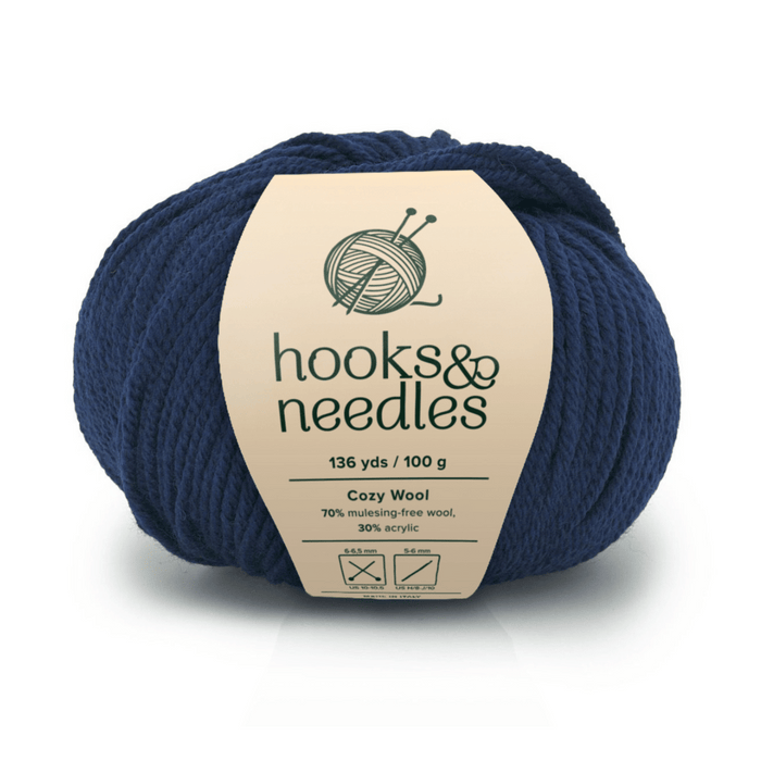 A skein of Cozy Wool in dark blue, 136 yds/100g, soft and breathable, 70% mulesing-free wool and 30% acrylic—ideal for luxurious, comfortable projects with quality you can feel.
