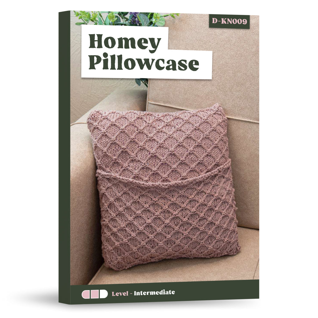 A pink, textured stitch pillowcase is featured on a beige couch on the cover of the "Homey Pillowcase Knitting Pattern" book.