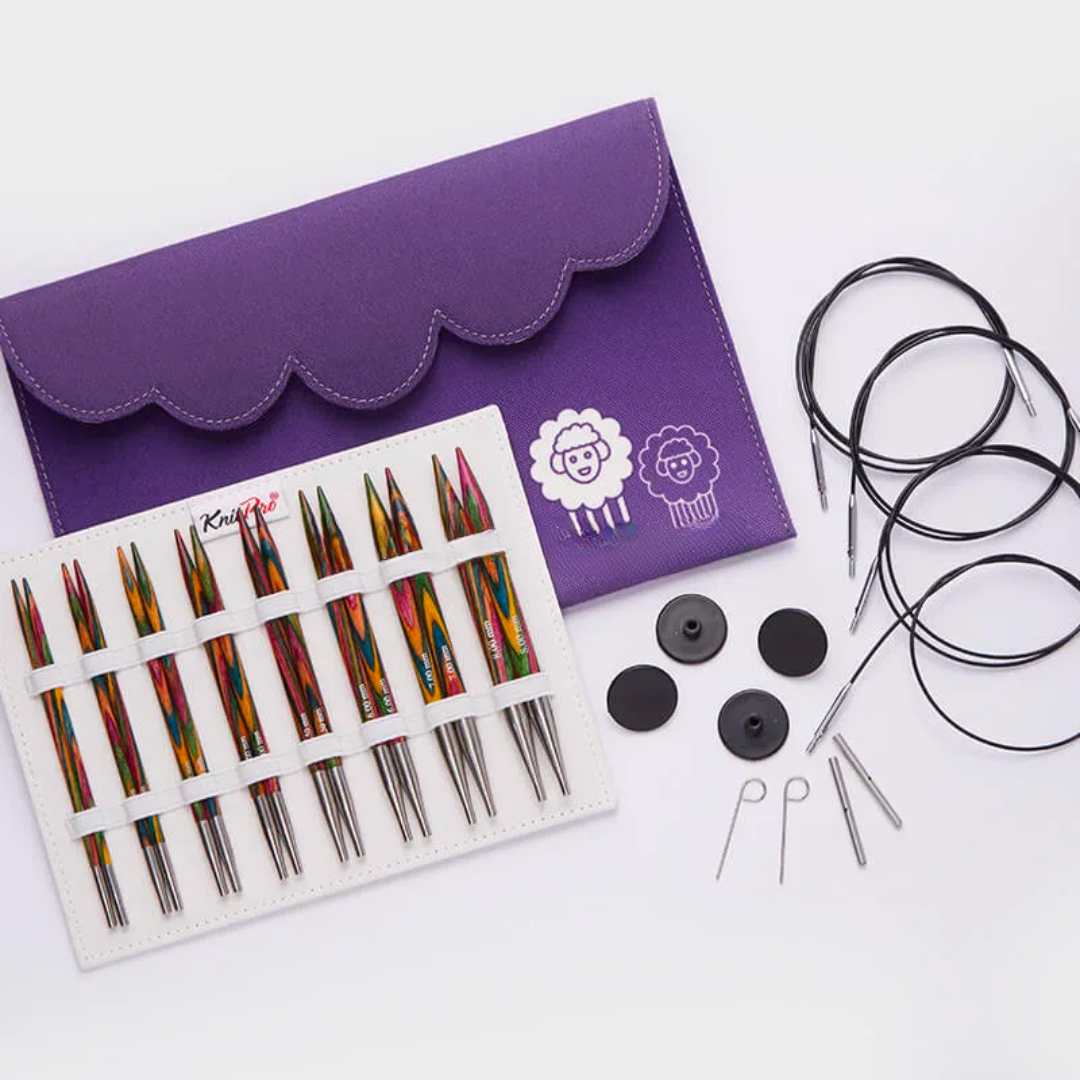 A Deluxe Wooden Knitting Needle Set with swivel cables and accessories displayed next to a purple case.